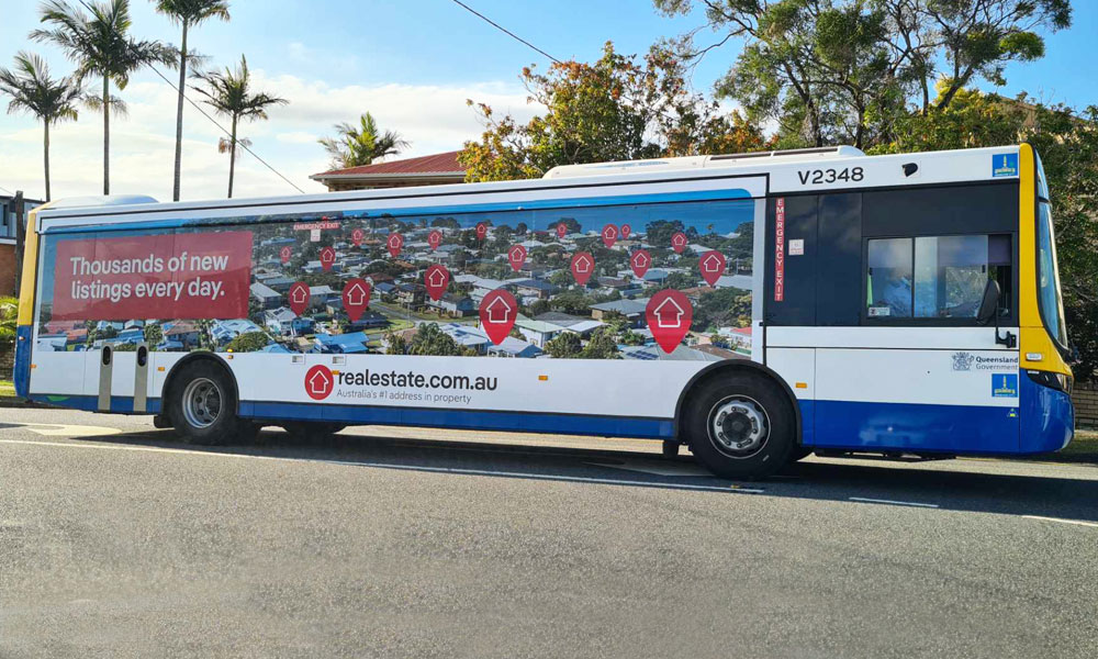 Photography for realestate.com.au ad campaign on buses - image shows bus on road with real estate photo on side